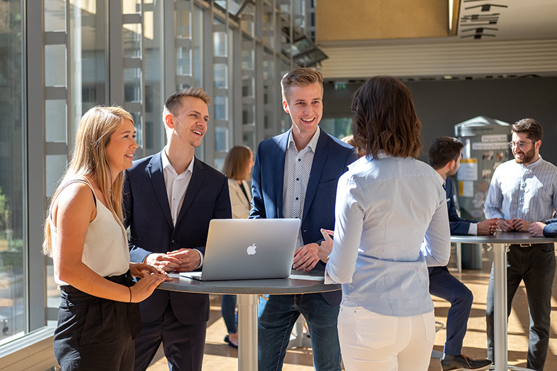 Vier Businessmenschen am Stehtisch